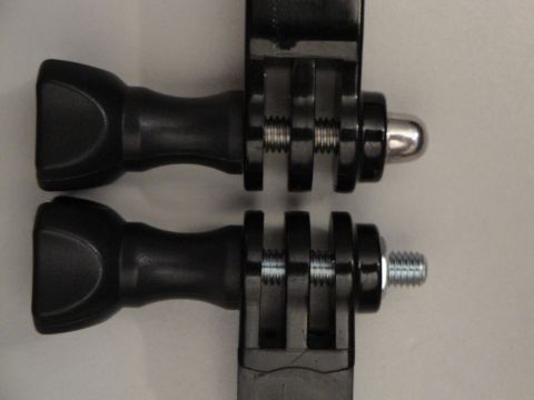 1993 Ford Taurus - Close-up of two black plastic camera mounting adapters with silver screws and threaded posts.