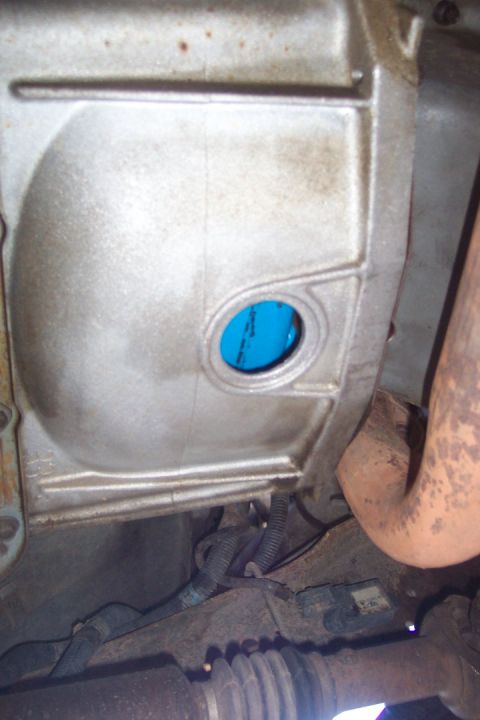1995 Ford Bronco - Transmission housing detail with blue fluid visible through a circular opening.