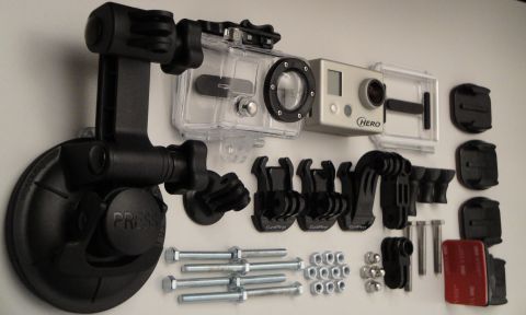 1993 Ford Taurus - A collection of GoPro camera gear, including a camera, protective case, suction mount, and assorted attachments.
