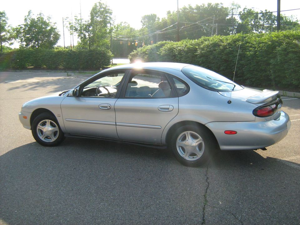 Silver sedan, side view, with a rear spoiler