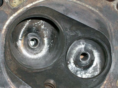 1973 Ford Ranchero - This image shows a close-up view of an engine cylinder head, two distinct combustion chambers with visible valve seats.