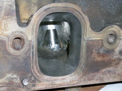 1973 Ford Ranchero - Close-up view of an engine cylinder head, showing internal port and valve. The metal appears aged and rusty.