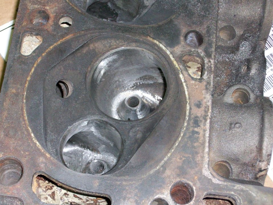 Engine cylinder head with two large valve openings and a smaller spark plug hole