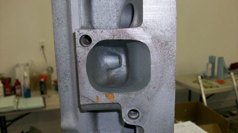 1973 Ford Ranchero - A close-up view of an engine cylinder head, showing the internal porting for intake and exhaust valves.