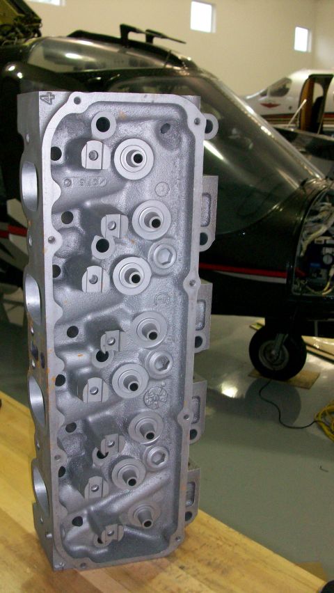 1973 Ford Ranchero - An aluminum engine cylinder head is displayed in front of an aircraft.