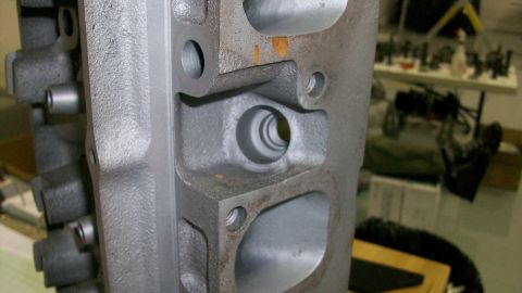 1973 Ford Ranchero - A close-up view of a gray cast iron engine cylinder head, showing its internal ports and bolt holes.