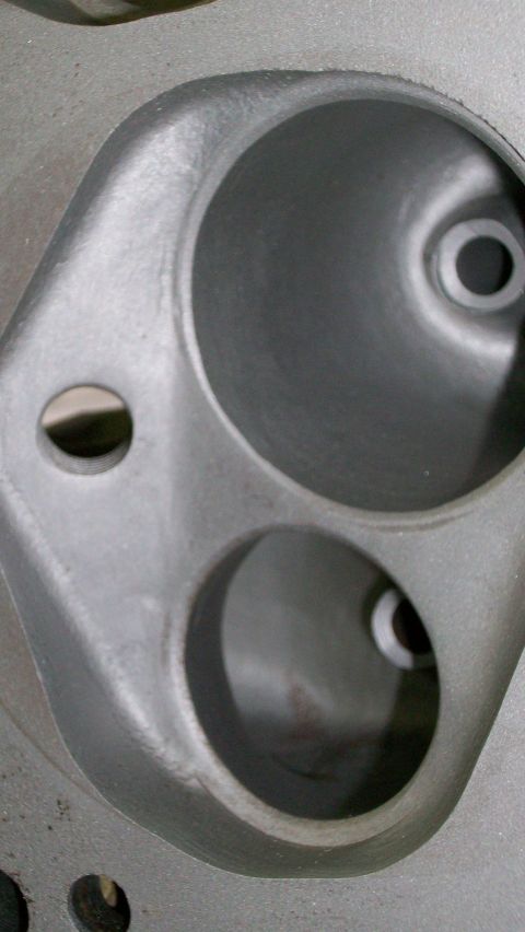 1973 Ford Ranchero - A detailed view of the intake and exhaust ports on an engine cylinder head, likely a performance upgrade.