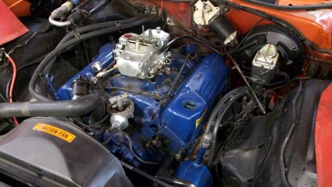 1973 Ford Ranchero - The engine bay shows a V8 engine with blue valve covers and a prominent carburetor.