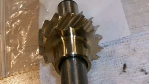 1973 Ford Ranchero - A close-up view of a brass gear mounted on a metal shaft, likely an engine component.
