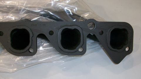1973 Ford Ranchero - Close-up of an exhaust manifold gasket, showing its port openings and some stamped text.