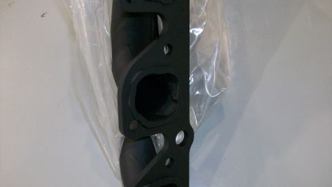 1973 Ford Ranchero - A black exhaust manifold is shown in its packaging, with a SuperMotors logo visible in the corner.