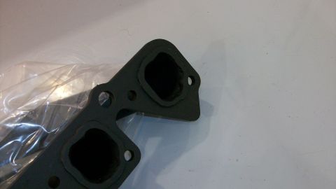 1973 Ford Ranchero - Close-up of an exhaust manifold part, likely for an engine, with two distinct ports.