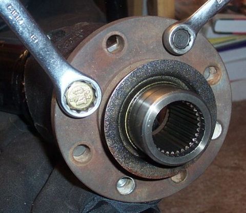 1990 Ford Bronco - I replaced the stupid 12mm, 12pt driveshaft bolts with new metric units from CAT. The new bolts take an 18mm wrench which clearly fits fine