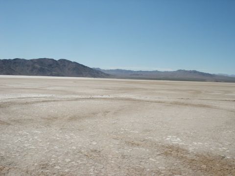 2000 Ford F-250 - A vast, arid landscape with mountains in the background and a dry, cracked ground in the foreground.