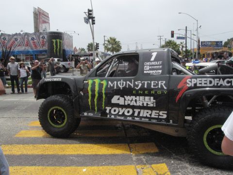 1986 Ford Bronco - Monster Energy sponsored off-road race truck with "4 Wheel Parts" and "Toyo Tires" branding.