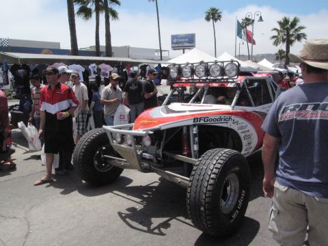 1986 Ford Bronco - Custom off-road buggy with racing decals parked outdoors near spectators.