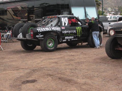 1986 Ford Bronco - Off-road race truck with Monster Energy livery and spare tires on the back.