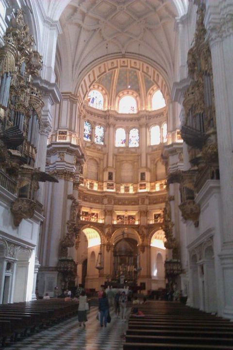 1991 Ford LTD Crown Victoria - The grand interior of a cathedral features ornate pipe organs and stained glass windows.