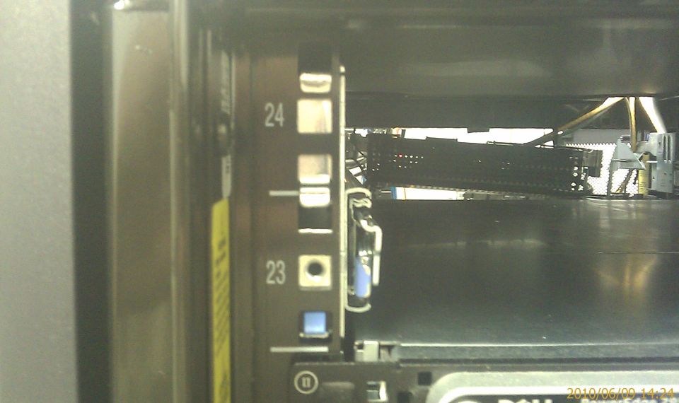 Server rack with numbered slots, showing internal components and cables