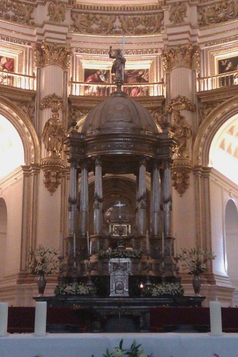 1991 Ford LTD Crown Victoria - An elaborate altar with columns, statues, and floral arrangements is shown inside a grand church.