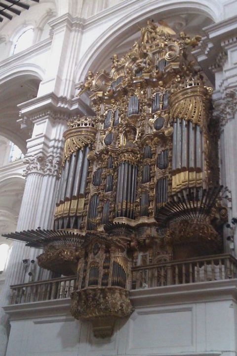 1991 Ford LTD Crown Victoria - Large pipe organ with intricate golden decorations and many pipes is a prominent feature in a grand interior space.