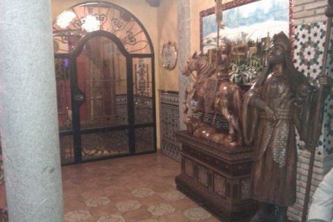 1991 Ford LTD Crown Victoria - An interior scene decorative tile work, an ornate metal gate, and wooden statues of a knight on horseback and a robed figure.
