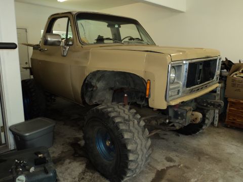 1990 Chevrolet Suburban - This tan pickup truck appears to be from the 1970s, not the 1990s as claimed.