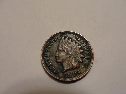 1995 Ford Bronco - Close-up of a 1904 Indian Head cent coin with visible text and date.