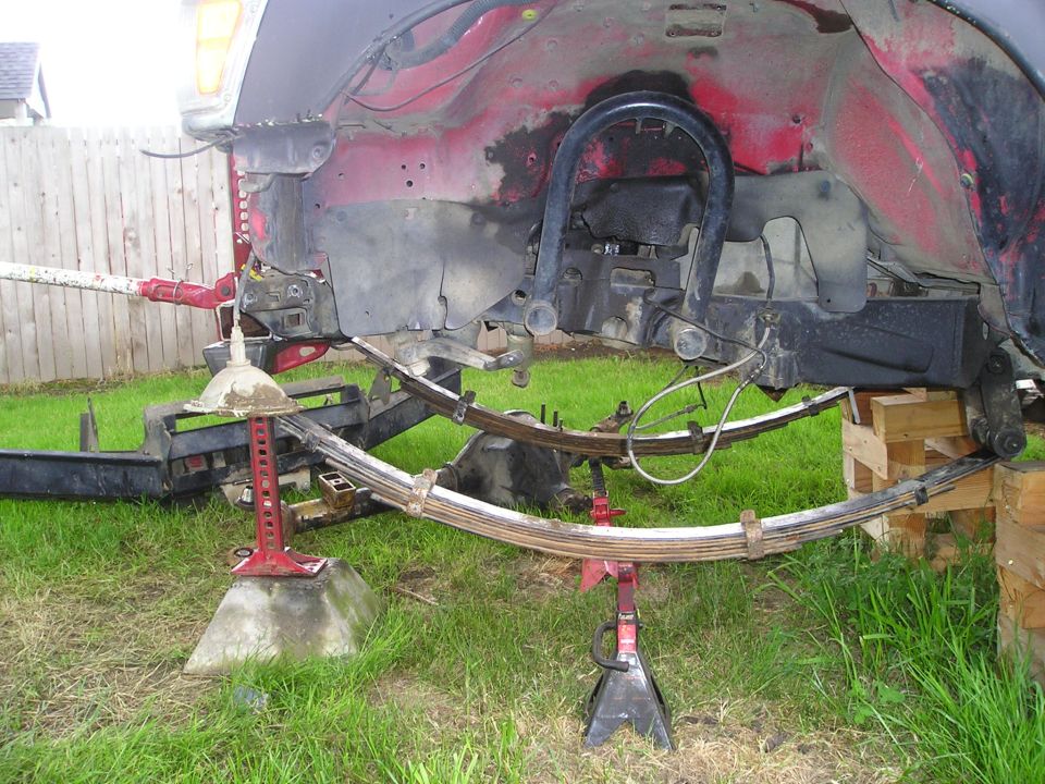 Red truck suspension with leaf springs on jacks