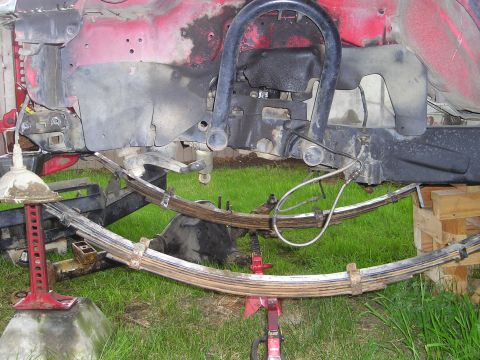 1990 Toyota Pickup/SR5 - Vehicle suspension components, including leaf springs, are visible while the vehicle is jacked up.