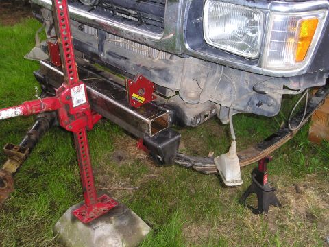 1990 Toyota Pickup/SR5 - Front suspension and bumper area of a 1990 Toyota Pickup, with a Hi-Lift jack and custom bumper fabrication in progress.