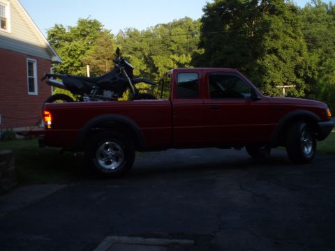 1997 Ford Ranger - Red 1997 Ford Ranger pickup truck with a dirt bike loaded in the bed.