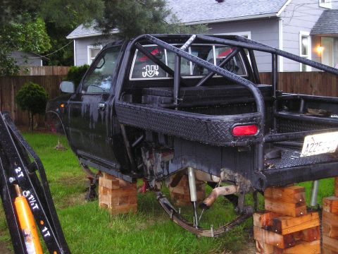 1990 Toyota Pickup/SR5 - This 1990 Toyota Pickup SR5 is undergoing suspension work, supported by wooden blocks.