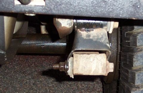 1990 Ford Bronco - The stock shackles really aren't up to the task. My passenger side bent (altho you can see my spring bushing was hurting, too)