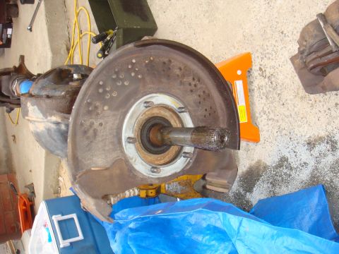 1992 Ford Bronco - Close-up of a vehicle's axle and brake rotor assembly, likely removed for maintenance.