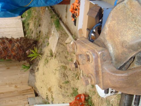 1992 Ford Bronco - Rusty metal part with bolts, likely from a vehicle's axle assembly.