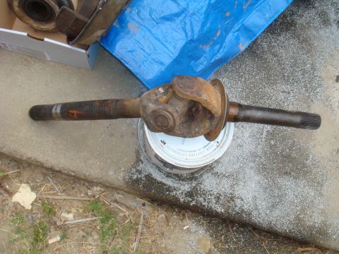 1992 Ford Bronco - A rusty driveshaft with a U-joint is shown resting on a can.