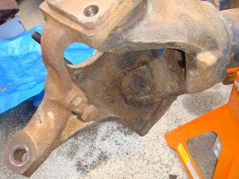 1992 Ford Bronco - Rusted axle part on an orange jack stand, likely from an older vehicle.