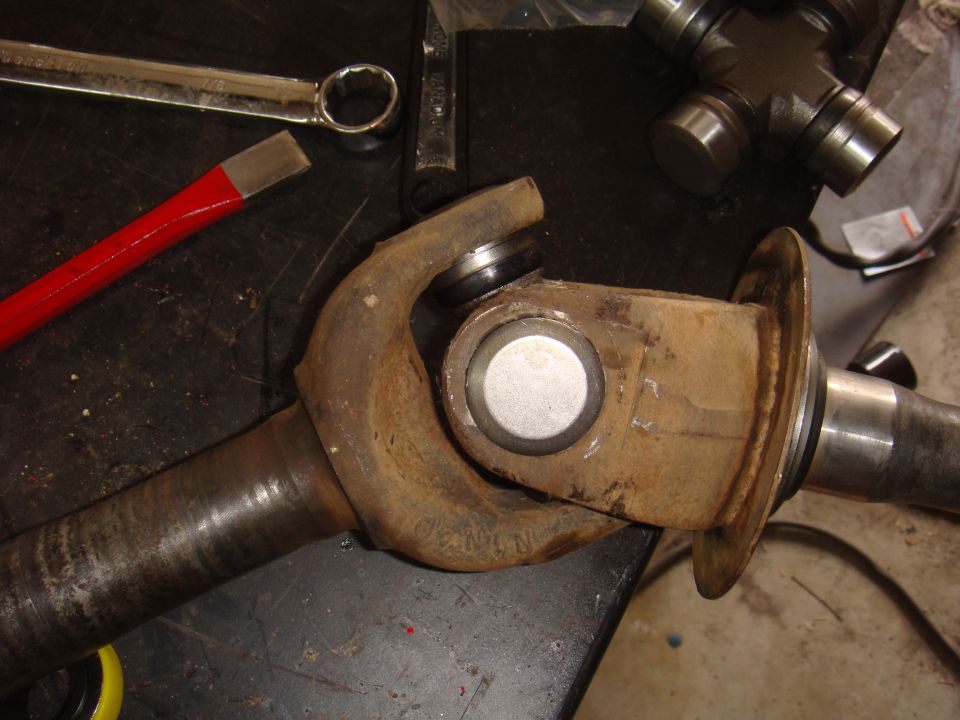 driveshaft u-joint with tools on workbench