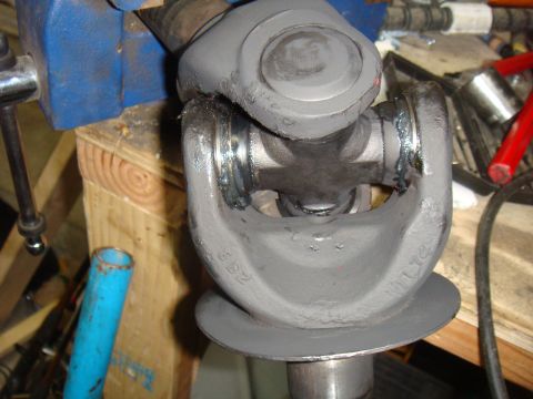 1992 Ford Bronco - Close-up of a universal joint being worked on, held securely in a vise for repair or modification.