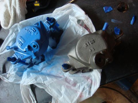 1992 Ford Bronco - Two brake calipers are shown, one freshly painted blue and the other in its original finish.