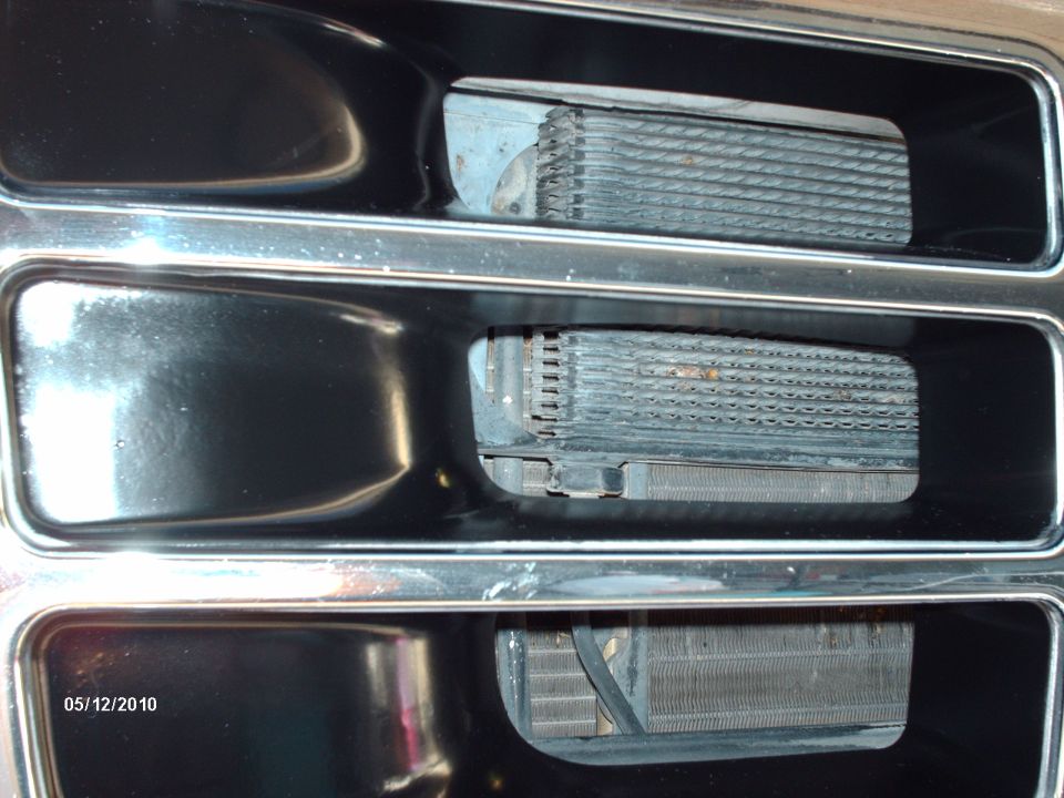 Grille with three openings showing oil coolers