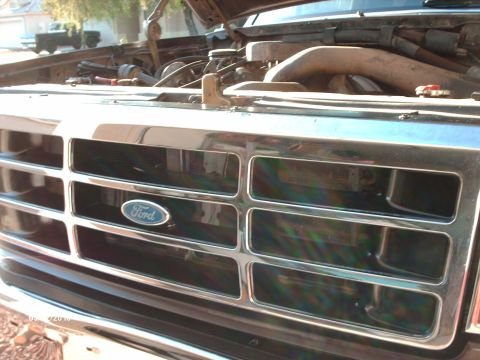 1992 Ford Bronco grille with Ford logo, hood open showing engine bay