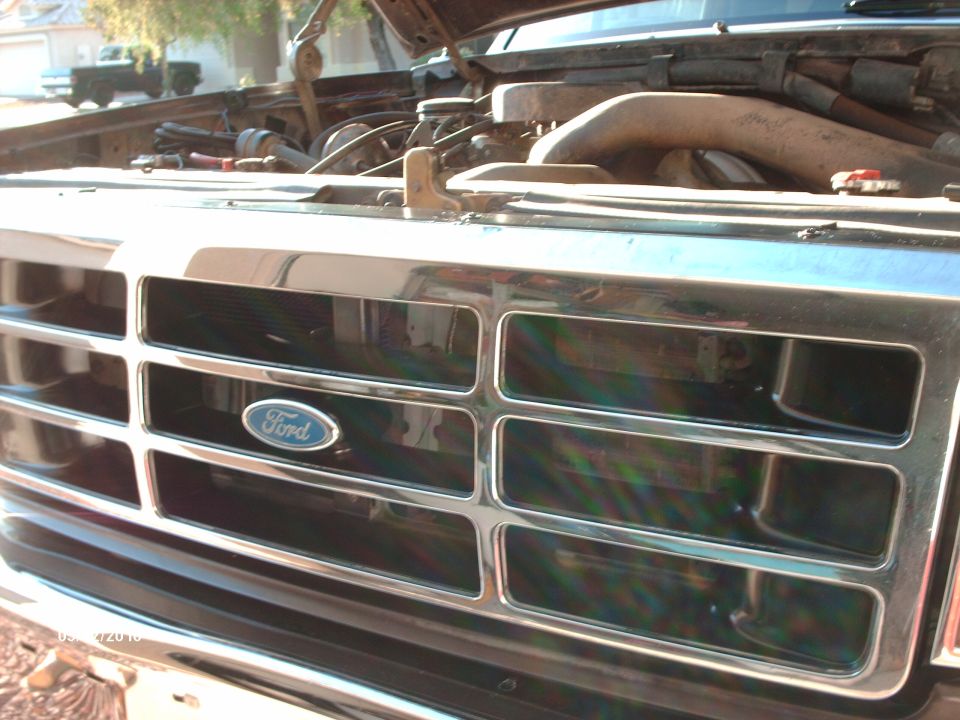 1992 Ford Bronco grille with Ford logo, hood open showing engine bay