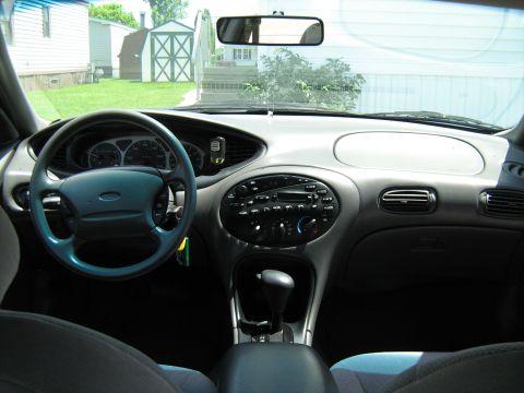 1988 Mercury Grand Marquis - Interior view of a car's dashboard, showing the steering wheel, center console, and radio.