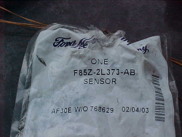 Ford parts bag labeled F85Z-2L373-AB sensor with barcode and 02/04/03 date