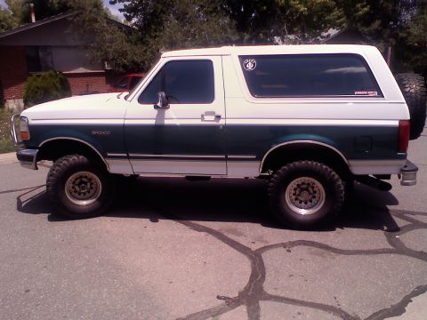 1996 Ford Bronco - This 1996 Ford Bronco is shown from the side, a two-tone white and green paint scheme.