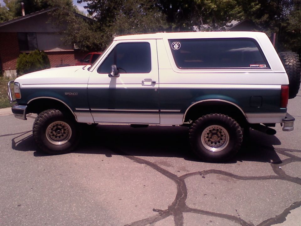 Side view of a 1996 Ford Bronco with white and green paint