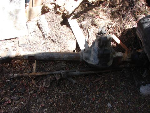 1978 Ford Bronco - This is a front axle assembly, likely from an older truck or SUV, resting on the ground outdoors.