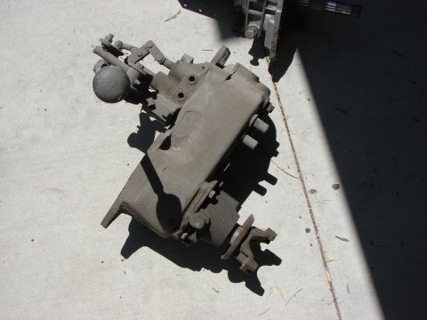 1978 Ford Bronco - A transfer case part is shown on a concrete surface, with a watermark for SUPERMOTORS.NET.
